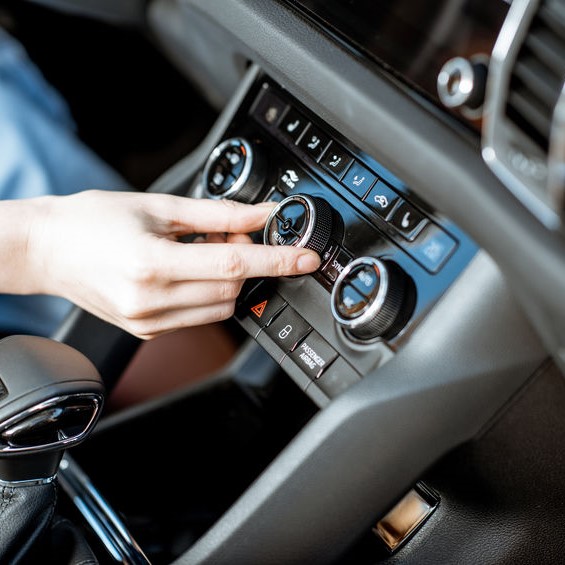 driver adjusting car ac